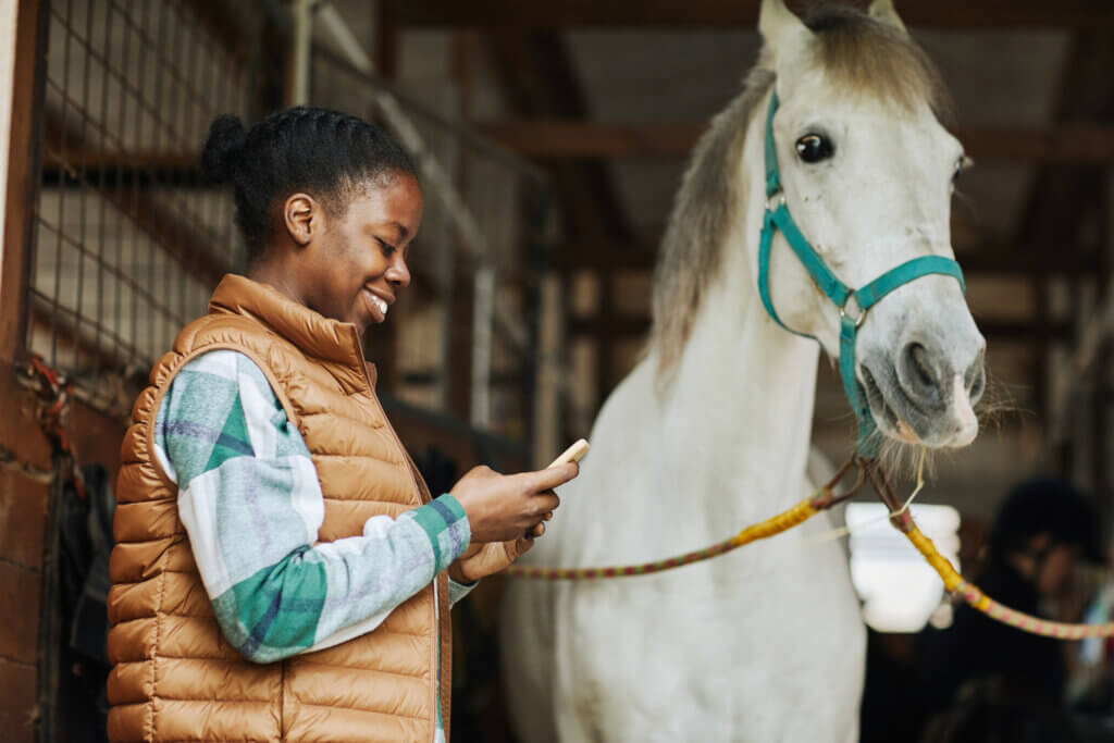 Black Young Woman in Stables at Horse Club